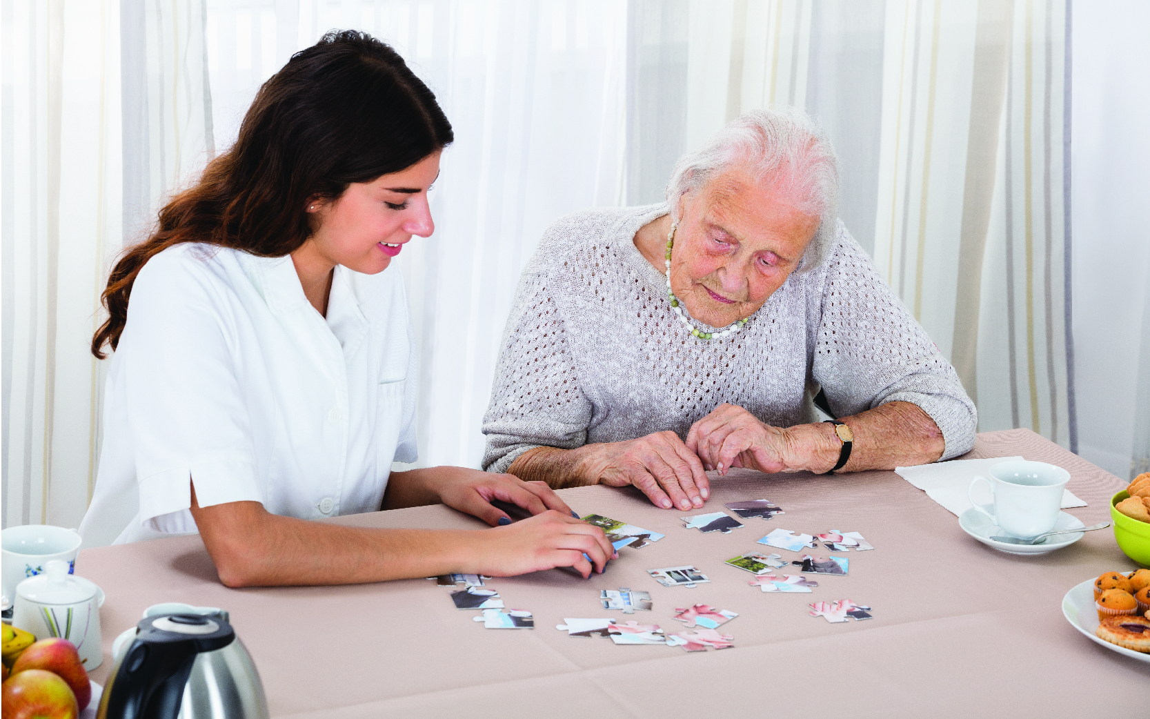 Image of woman doing puzzle with elderly woman