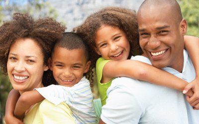 Mother and father give kids a piggy back