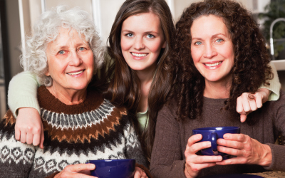 Grandmother, mother and daughter pose together