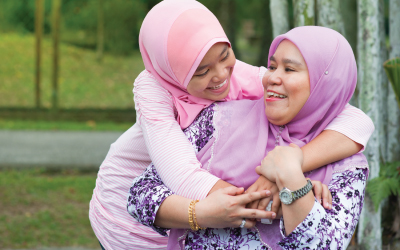 Grandmother, mother and daughter pose together