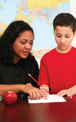teacher and student who is writing