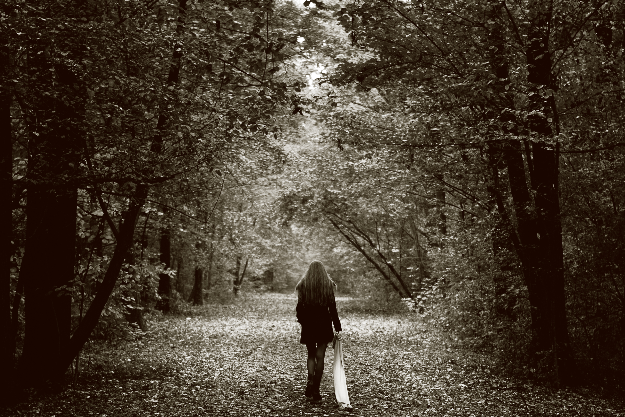 Women in the woods on a trail in black and white