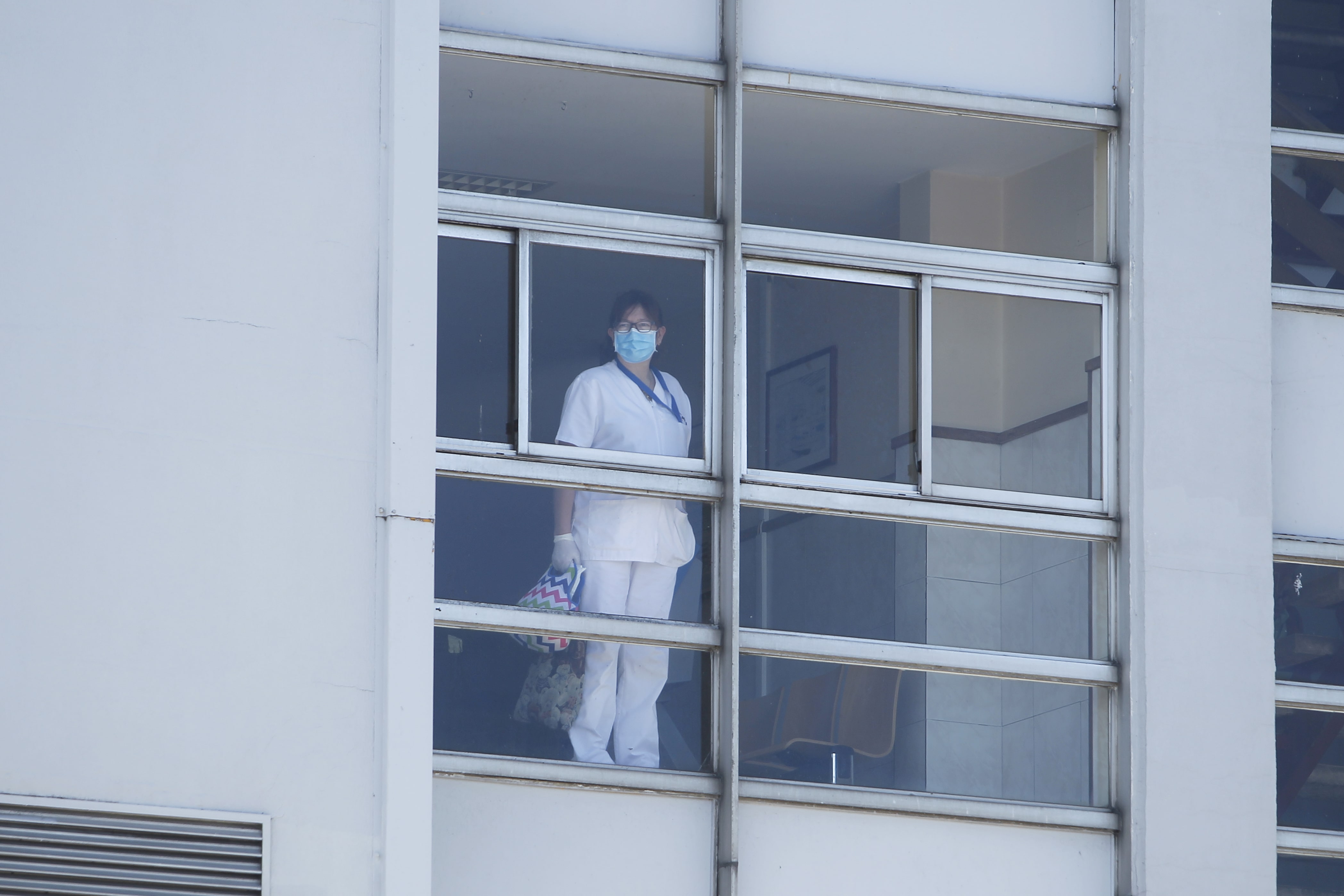 healthcare worker looking out window
